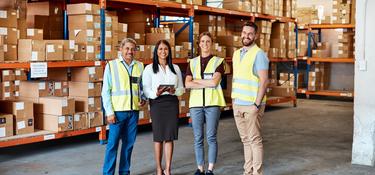 Four team members in a warehouse 