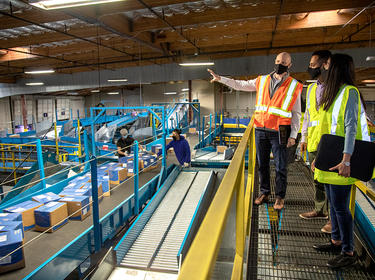 Prologis team members tour a sorting facility in Fremont, California.