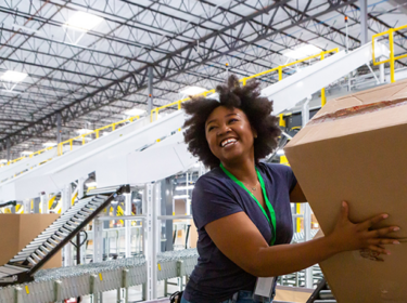 LED_lighting_smiling_woman_bright_lit_warehouse