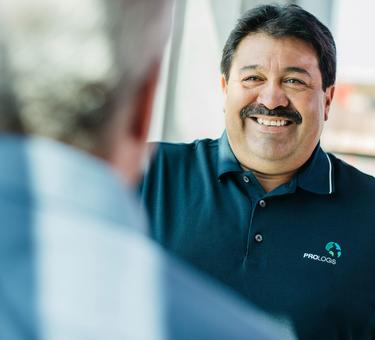 Maintenance technician David Huajardo smiling at a coworker Maintenance technician David Huajardo smiling at a coworker