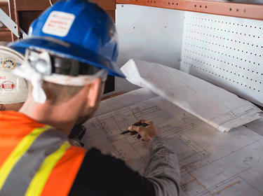 Construction workers reviewing blueprints Construction workers reviewing blueprints